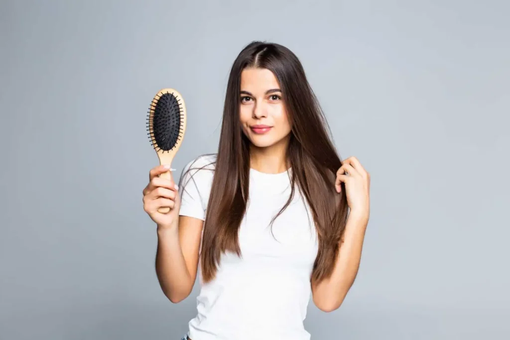 A girl standing with comb in her hand