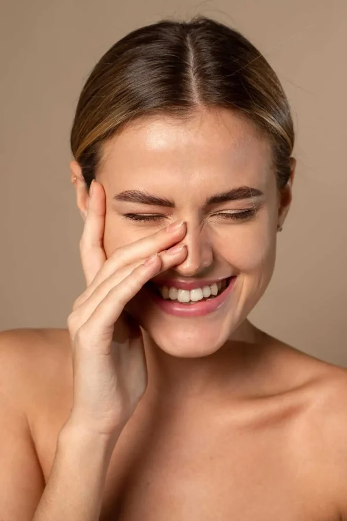 A girl smiling showing skincare